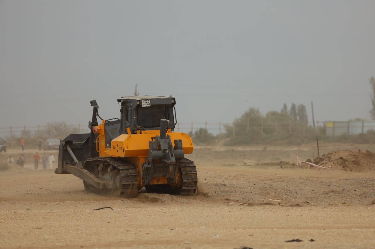 A Bulldozer on Brown Field